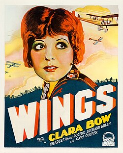 The theatrical poster of Wings. It focuses on Clara Bow, with war planes in the background.