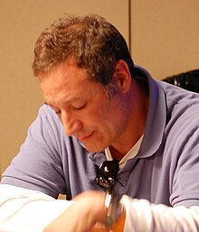 A man looking down at a table